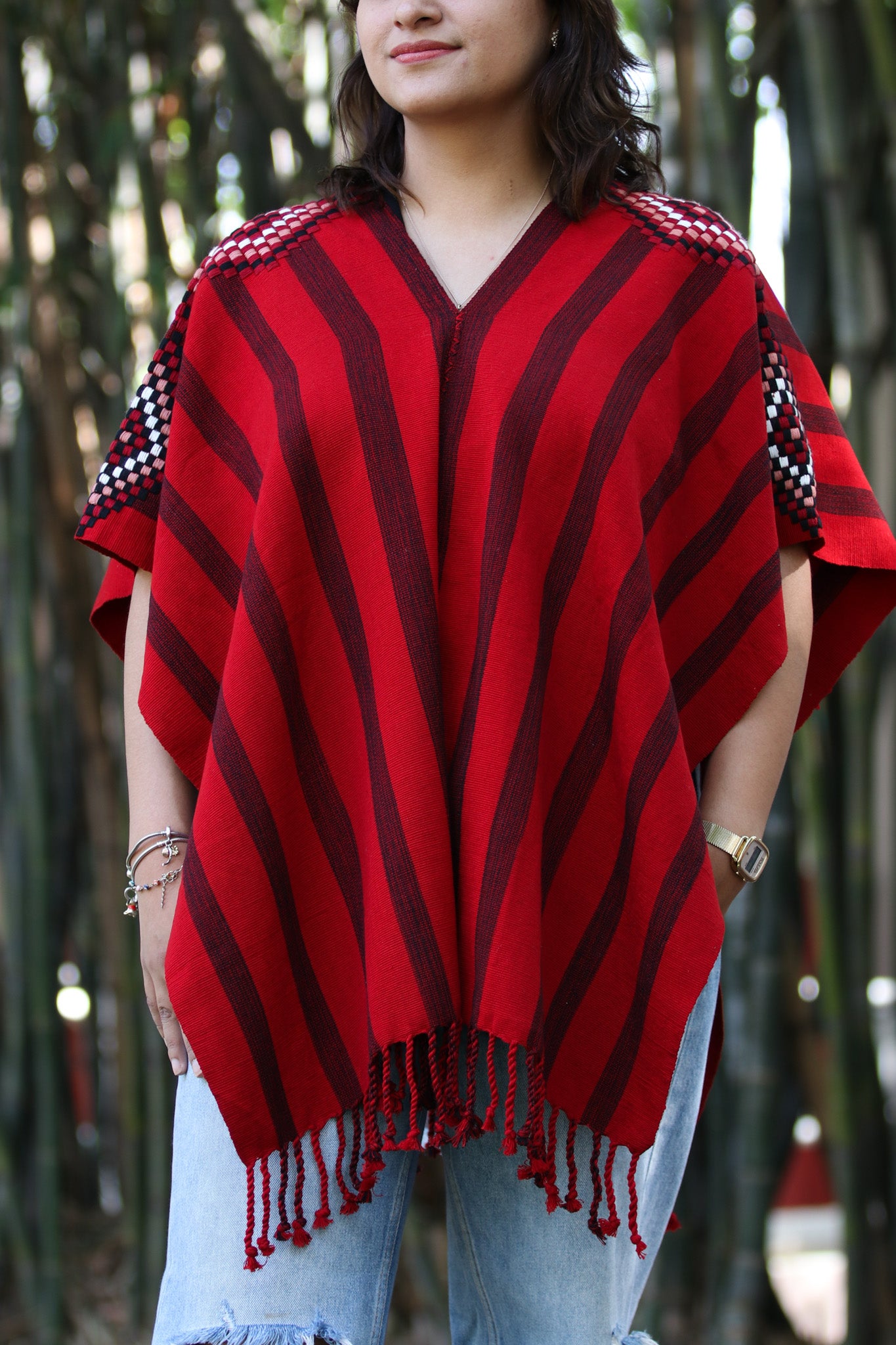 RED PONCHO WITH BLACK STRIPES AND DETAILED SLEEVES