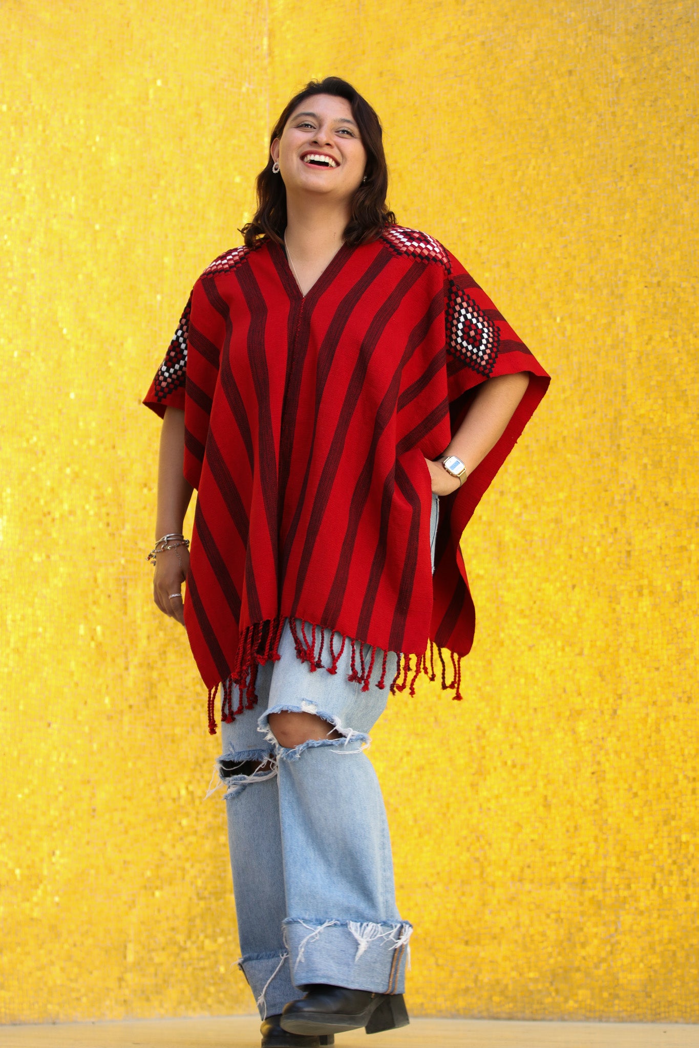 RED PONCHO WITH BLACK STRIPES AND DETAILED SLEEVES