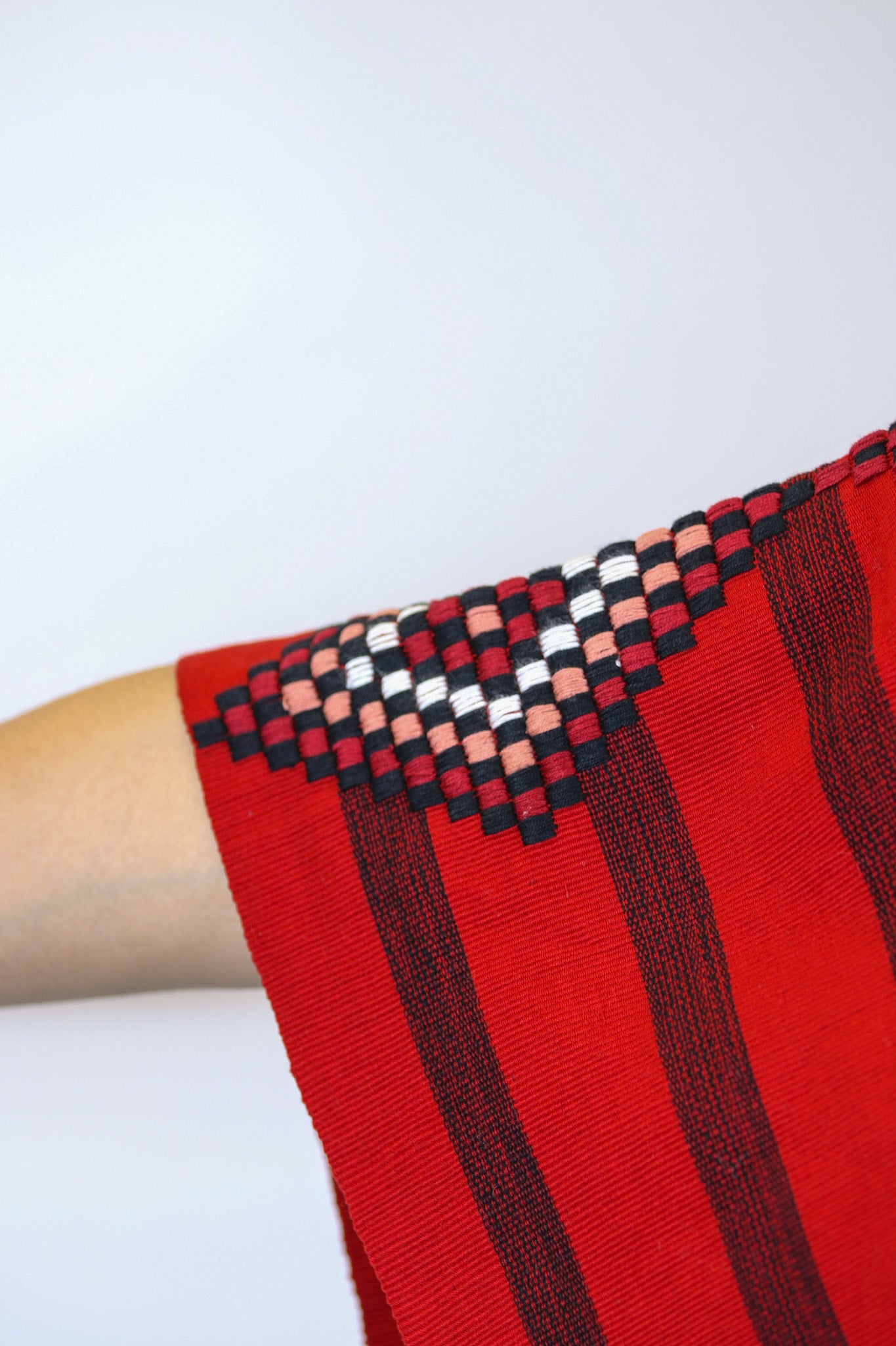 RED PONCHO WITH BLACK STRIPES AND DETAILED SLEEVES